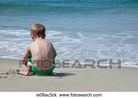 Male toddler playing on beach View Large Photo Image Stock Image - Male toddler playing on beach. Fotosearch