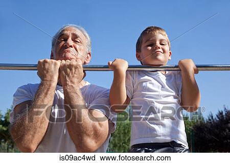 Man and grandson doing chin-ups View Large Photo Image Stock Image - Man and grandson doing chin-ups. Fotosearch