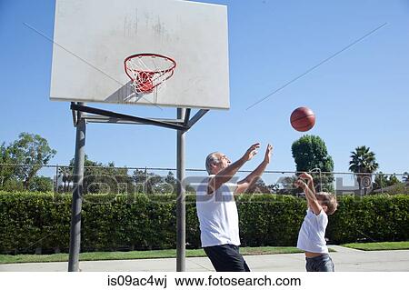 Man and grandson playing basketball View Large Photo Image Stock Image - Man and grandson playing basketball. Fotosearch