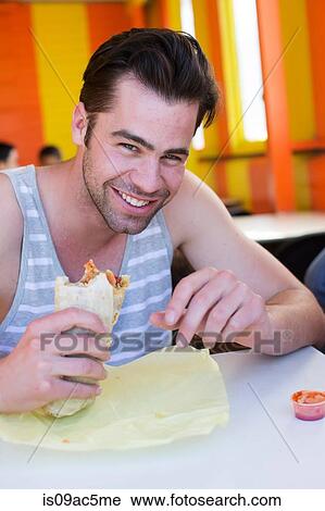 Man enjoying Lebanese bread wrap View Large Photo Image Stock Image - Man enjoying Lebanese bread wrap. Fotosearch