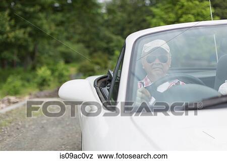 Man enjoying leisurely drive in sports car View Large Photo Image Stock Photo - Man enjoying leisurely drive in sports car. Fotosearch