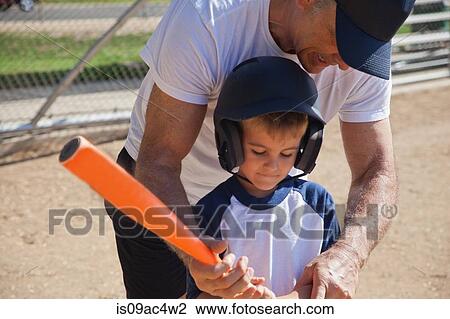 Stock Image - Man teaching grandson to play baseball. Fotosearch