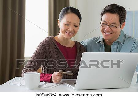 Picture - Mature couple home shopping. Fotosearch