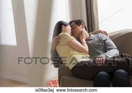 Mature couple hugging on sofa View Large Photo Image Stock Image - Mature couple hugging on sofa. Fotosearch