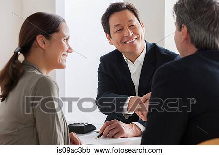 Stock Image - Mature couple meeting businessman. Fotosearch