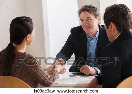 Stock Photo - Mature couple meeting businessman. Fotosearch