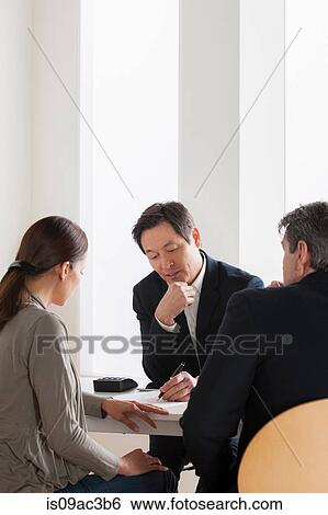 Stock Photograph - Mature couple meeting businessman. Fotosearch