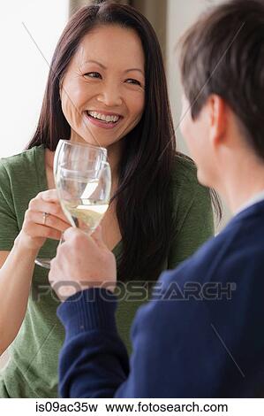 Stock Photo - Mature couple toasting with white wine. Fotosearch