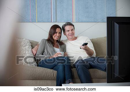 Mature couple watching tv View Large Photo Image Picture - Mature couple watching tv. Fotosearch