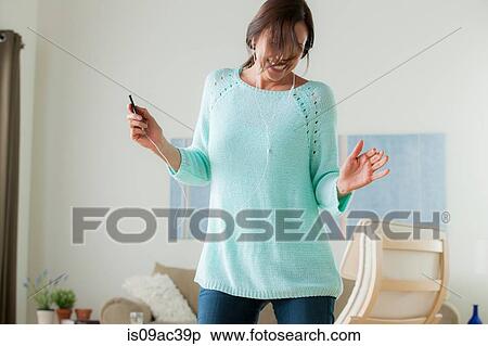 Stock Photography - Mature dancing with mp3 player. Fotosearch