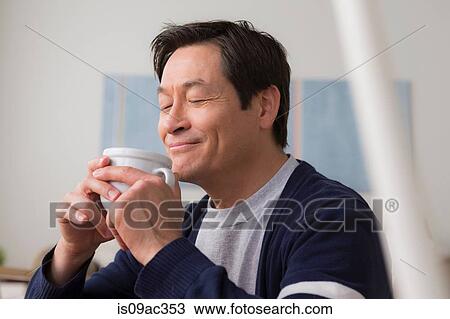Stock Image - Mature man drinking coffee. Fotosearch
