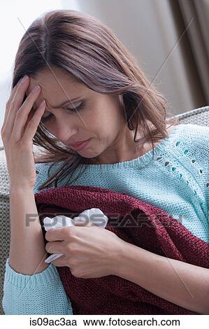Stock Image - Mature woman with headache. Fotosearch