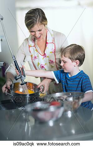 Mother and son washing vegetables in sink at home View Large Photo Image Stock Image - Mother and son washing vegetables in sink at home. Fotosearch