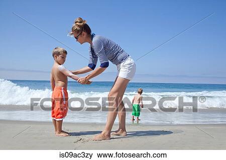 Mother and sons on beach View Large Photo Image Stock Photo - Mother and sons on beach. Fotosearch