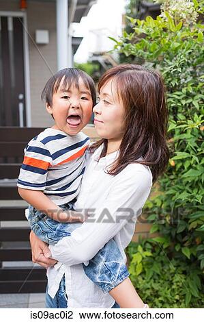 Mother holding son View Large Photo Image Stock Image - Mother holding son. Fotosearch