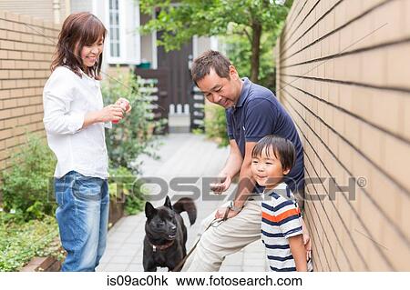 Stock Image - Parents with son and pet dog. Fotosearch
