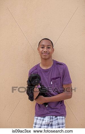 Portrait of boy holding dog View Large Photo Image Stock Photo - Portrait of boy holding dog. Fotosearch