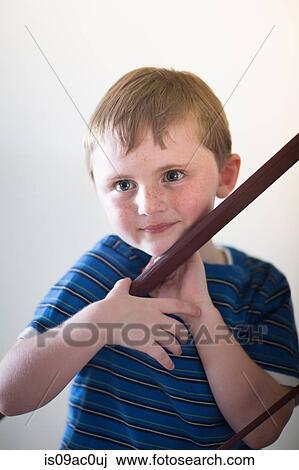 Stock Image - Portrait of boy leaning on railing. Fotosearch
