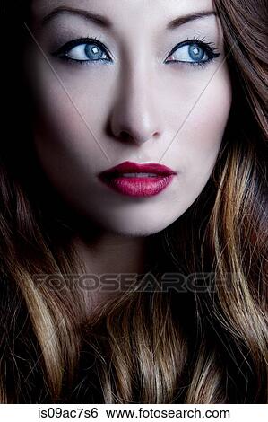 Stock Photograph - Portrait of brunette woman looking sideways. Fotosearch