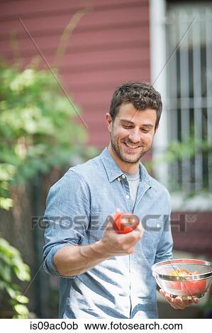 Portrait of man holding apple View Large Photo Image Stock Image - Portrait of man holding apple. Fotosearch