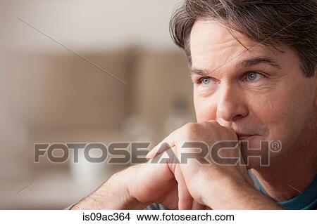 Picture - Portrait of mature man with hands on chin. Fotosearch