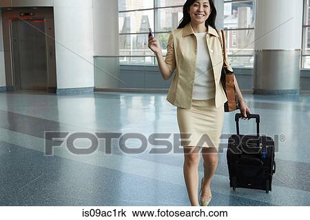 Portrait of woman in Staten Island Ferry terminal with smartphone and wheeled suitcase View Large Photo Image Stock Image - Portrait of woman in Staten Island Ferry terminal with smartphone and wheeled suitcase. Fotosearch