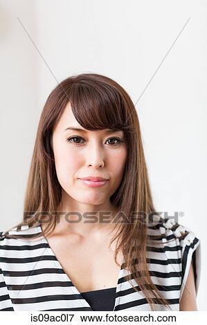 Stock Photo - Portrait of woman wearing striped top. Fotosearch