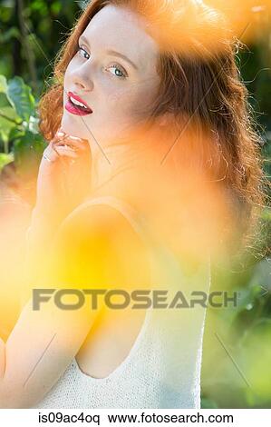 Portrait of young woman looking over her shoulder View Large Photo Image Stock Photography - Portrait of young woman looking over her shoulder. Fotosearch