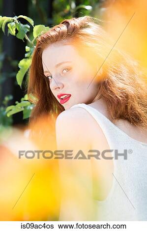 Portrait of young woman with red hair View Large Photo Image Stock Photograph - Portrait of young woman with red hair. Fotosearch