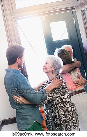 Son greeting mother in hallway View Large Photo Image Stock Image - Son greeting mother in hallway. Fotosearch