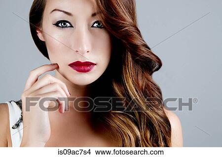 Studio portrait of brunette woman touching cheek View Large Photo Image Picture - Studio portrait of brunette woman touching cheek. Fotosearch