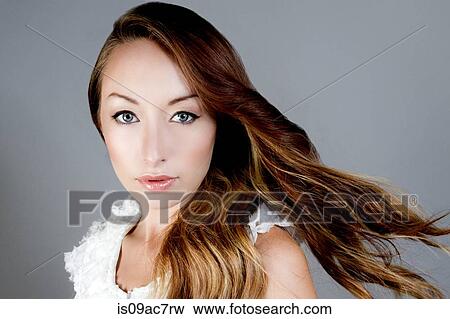 Stock Photo - Studio portrait of brunette woman looking at camera. Fotosearch
