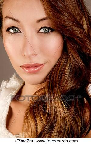 Stock Photograph - Studio portrait of brunette woman looking at camera. Fotosearch
