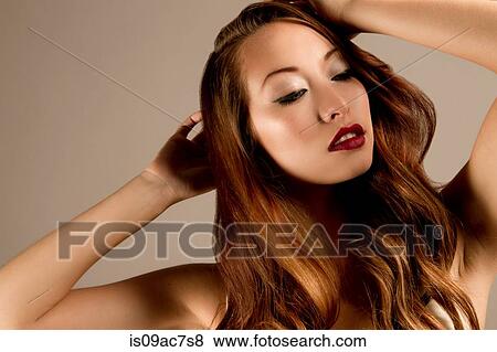 Studio portrait of brunette woman with hands in hair View Large Photo Image Stock Photo - Studio portrait of brunette woman with hands in hair. Fotosearch