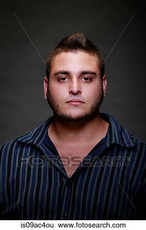 Studio portrait of young man in striped shirt View Large Photo Image Stock Photograph - Studio portrait of young man in striped shirt. Fotosearch