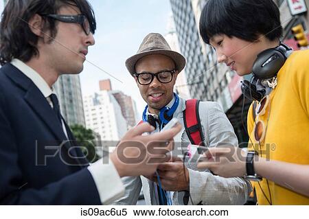 Three friends on street with mp3 player View Large Photo Image Stock Photography - Three friends on street with mp3 player. Fotosearch