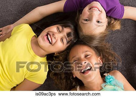 Three girls laughing, overhead view View Large Photo Image Stock Photograph - Three girls laughing, overhead view. Fotosearch