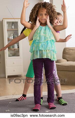 Picture - Three girls with arms out. Fotosearch