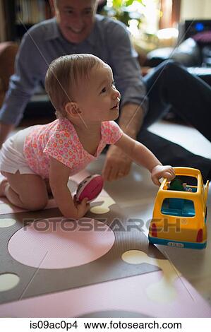 Toddler girl playing with toy car View Large Photo Image Picture - Toddler girl playing with toy car. Fotosearch