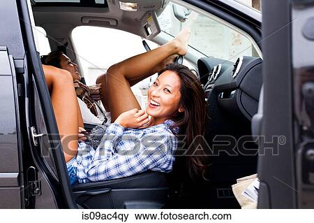 Two female friends back to front in car View Large Photo Image Stock Photo - Two female friends back to front in car. Fotosearch
