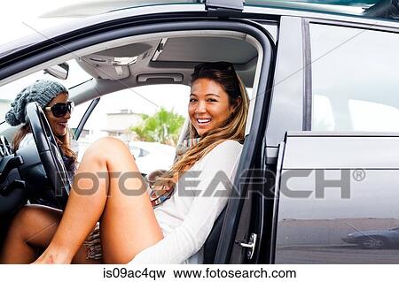 Stock Photo - Two female friends in car. Fotosearch
