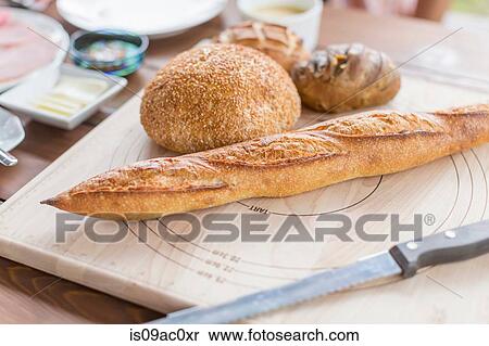 Variety of bread on chopping board View Large Photo Image Stock Photography - Variety of bread on chopping board. Fotosearch
