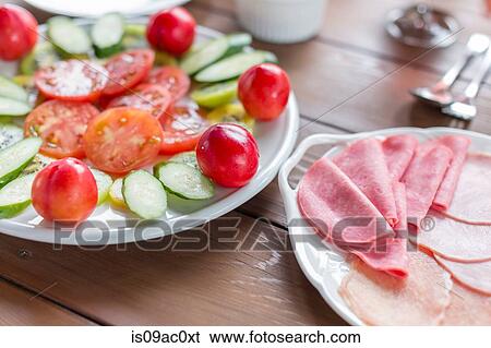 Stock Photograph - Variety of ham and cut vegetables. Fotosearch