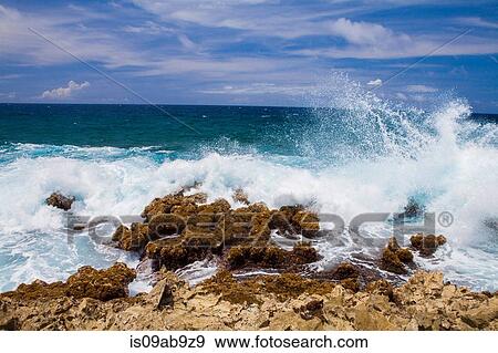 Waves crashing over rocks, Palm Beach, Oranjestad, Aruba View Large Photo Image Stock Photo - Waves crashing over rocks, Palm Beach, Oranjestad, Aruba. Fotosearch