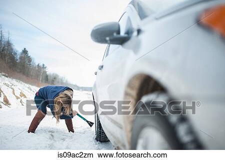 Woman digging car out from snow View Large Photo Image Picture - Woman digging car out from snow. Fotosearch