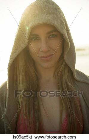 Stock Photograph - Woman in hoodie looking at camera. Fotosearch