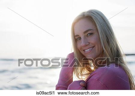 Stock Image - Woman looking sideways at camera. Fotosearch