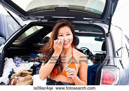 Woman putting on suncream, Hermosa Beach, California, USA View Large Photo Image Stock Image - Woman putting on suncream, Hermosa Beach, California, USA. Fotosearch
