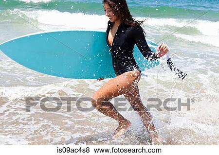 Woman running through waves, Hermosa Beach, California, USA View Large Photo Image Stock Photo - Woman running through waves, Hermosa Beach, California, USA. Fotosearch