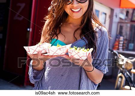 Stock Image - Woman with takeaway food, Hermosa Beach, California, USA. Fotosearch